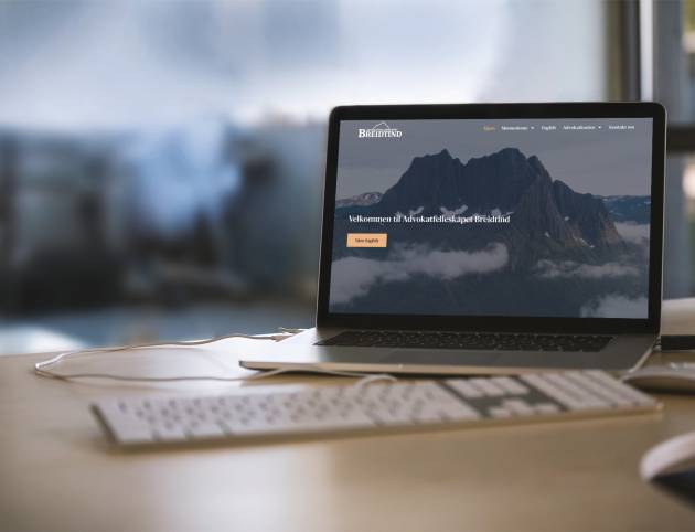 mockup-featuring-a-macbook-placed-on-a-desk-at-an-office-2441-el1
